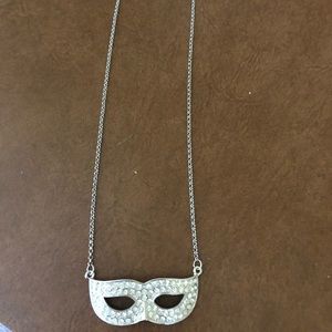 Costume jewelry mask on chain chain is about 12 to 18 inches silver mask